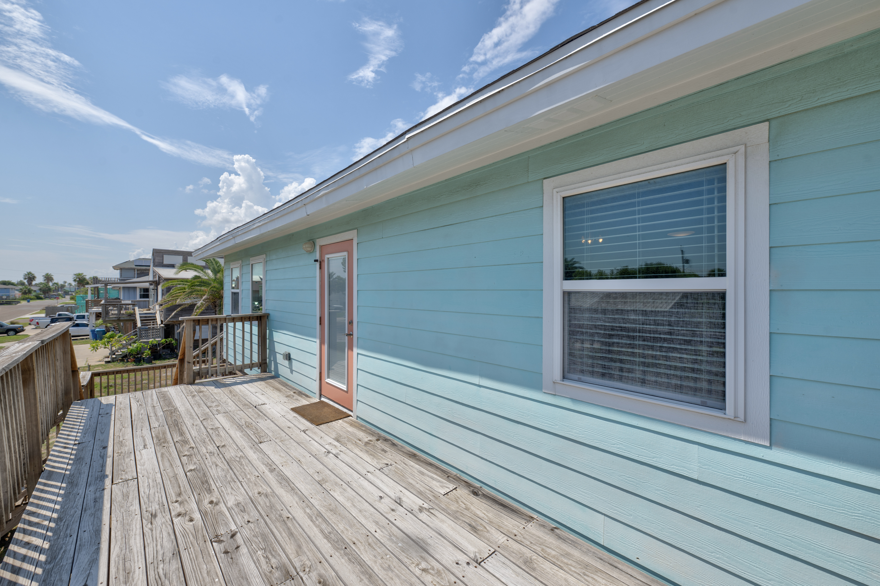 This spacious elevated deck offers a refreshing coastal outlook, perfect for enjoying warm breezes and sunny Texas skies