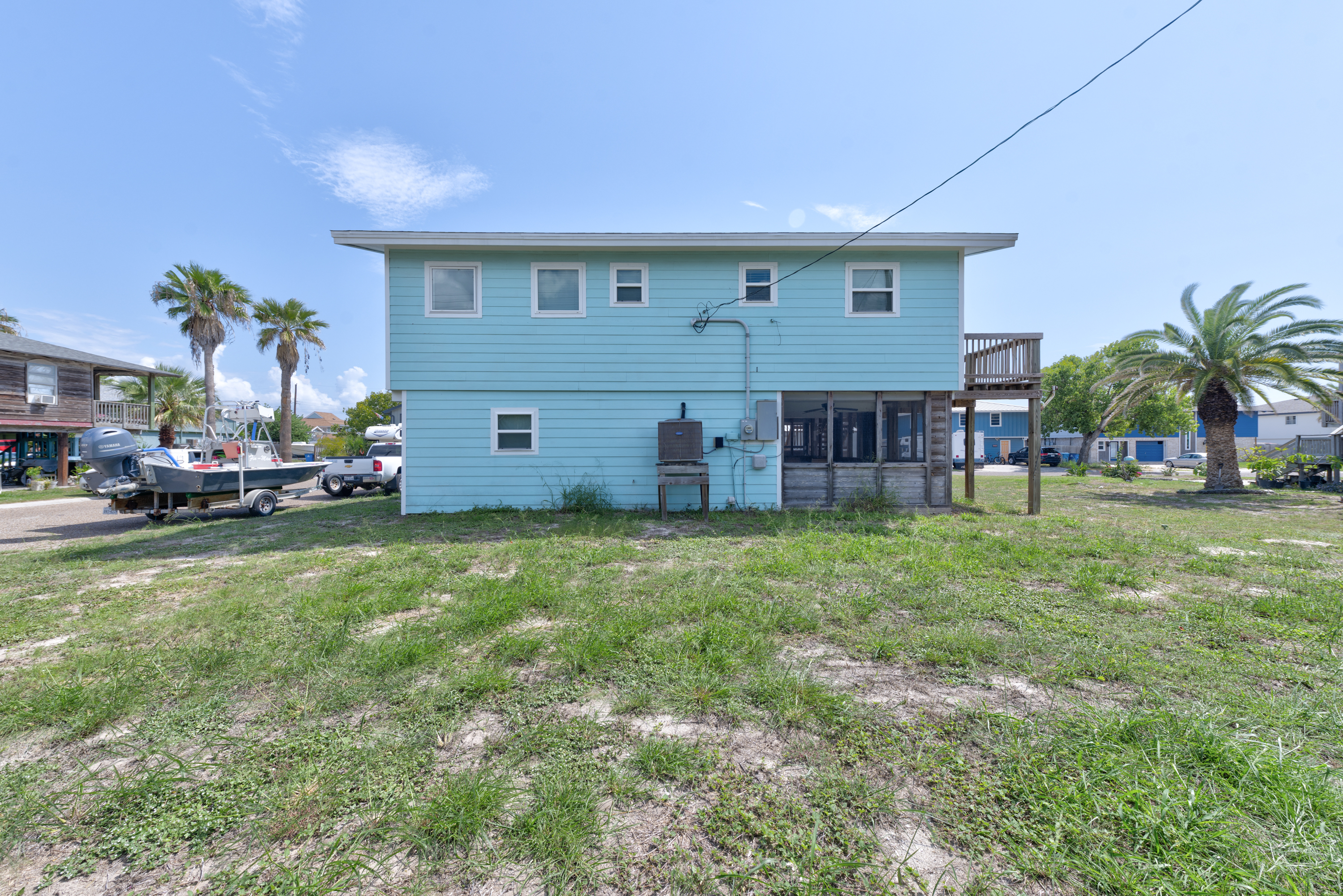 This spacious backyard is a great spot for lawn games, relaxing in the shade, or prepping for a day out on the water