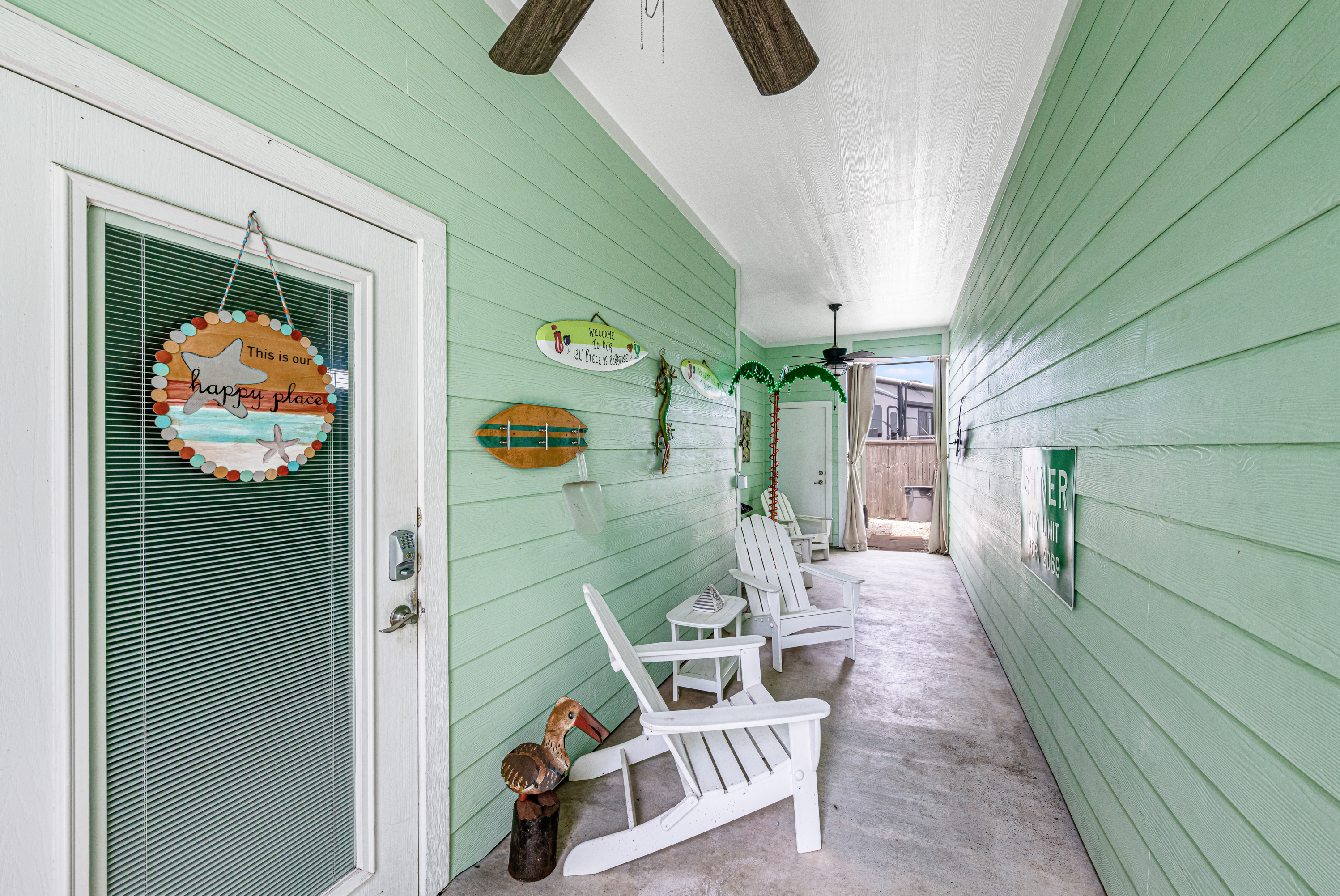 charming covered patio area with a bright and cheerful coastal design