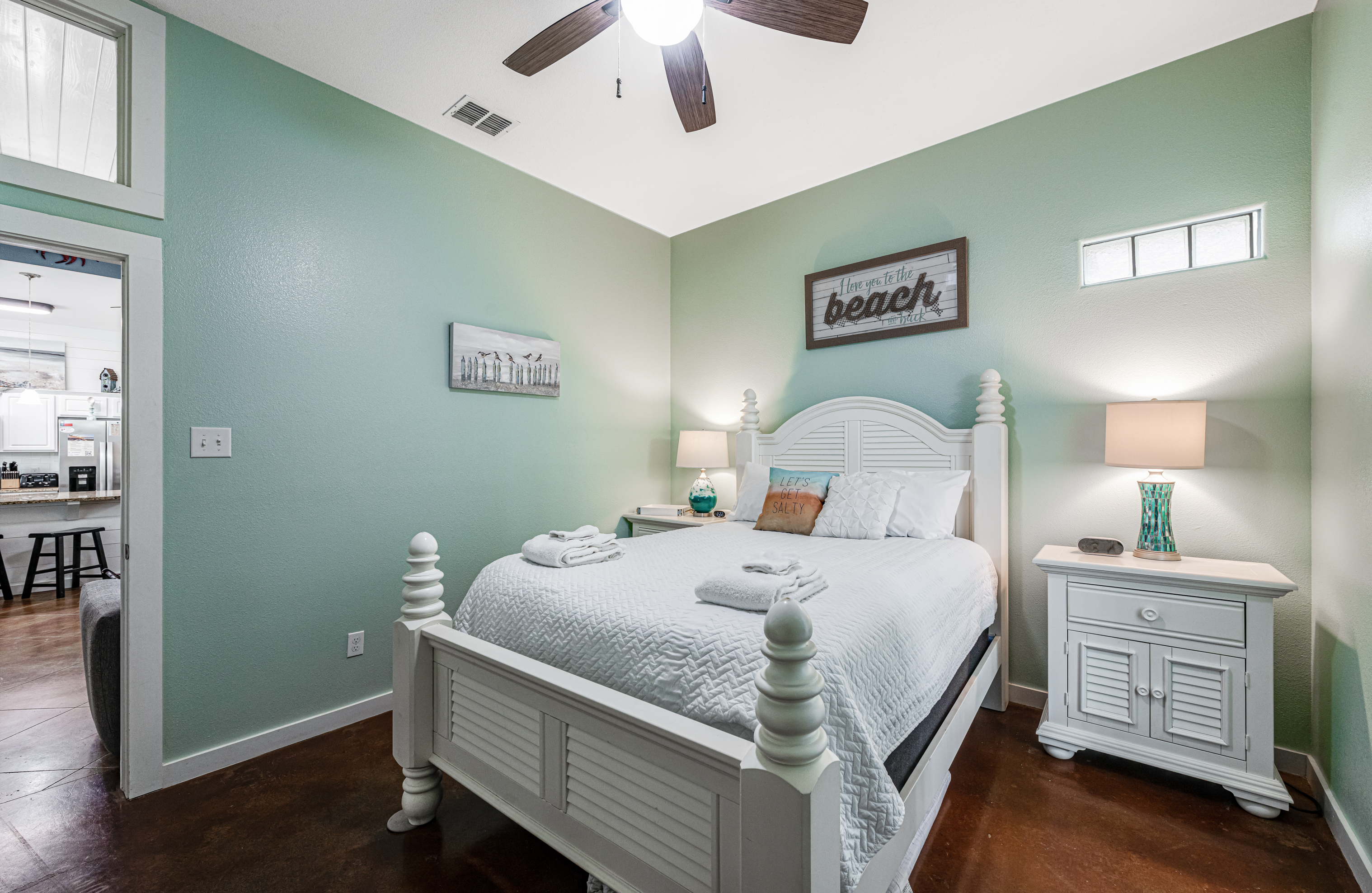 Cozy queen bedroom with coastal artwork and décor accents that complete the seaside retreat atmosphere