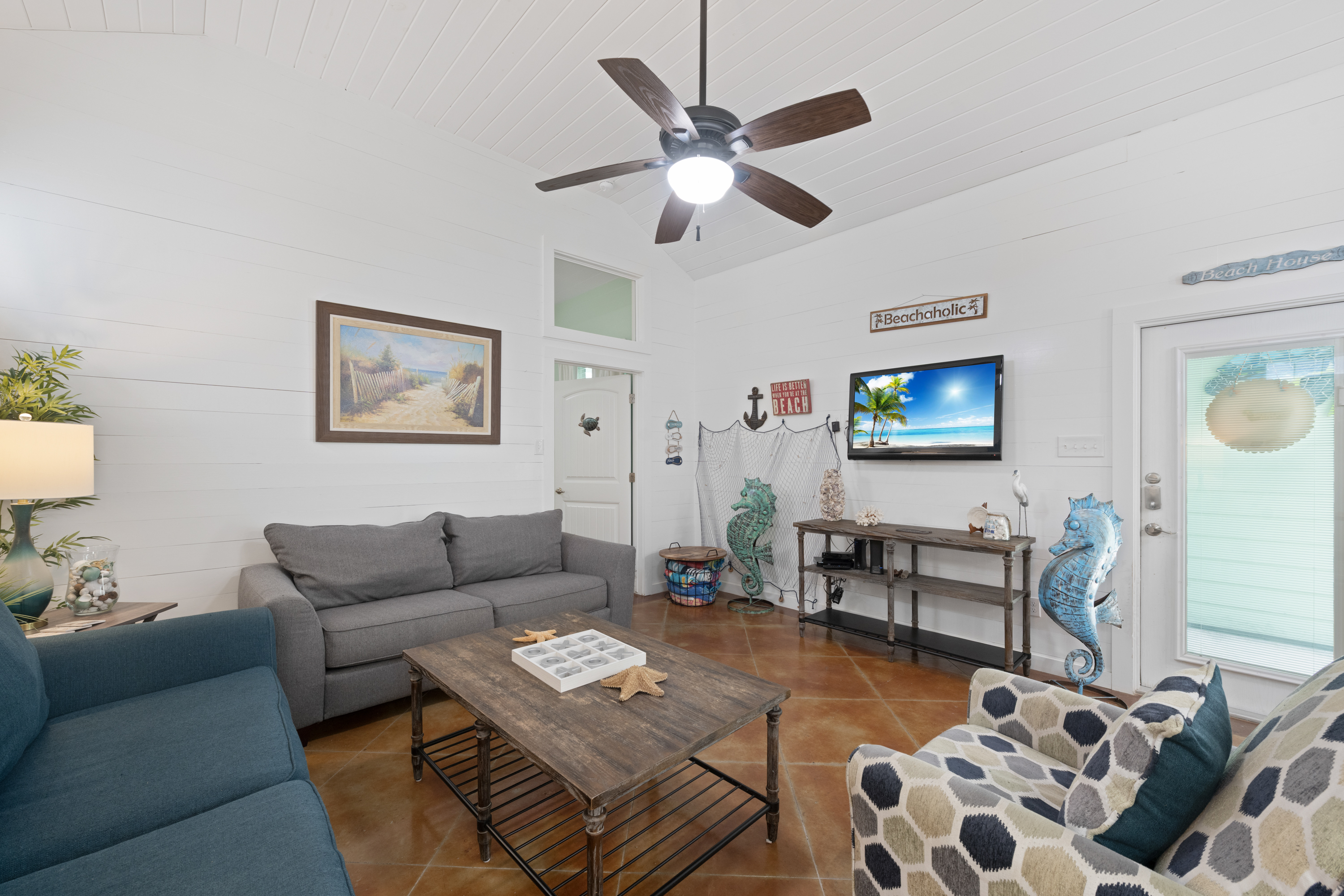 Living Area Showcases Coastal and Sea Life Charm, Complete with Cozy Seating