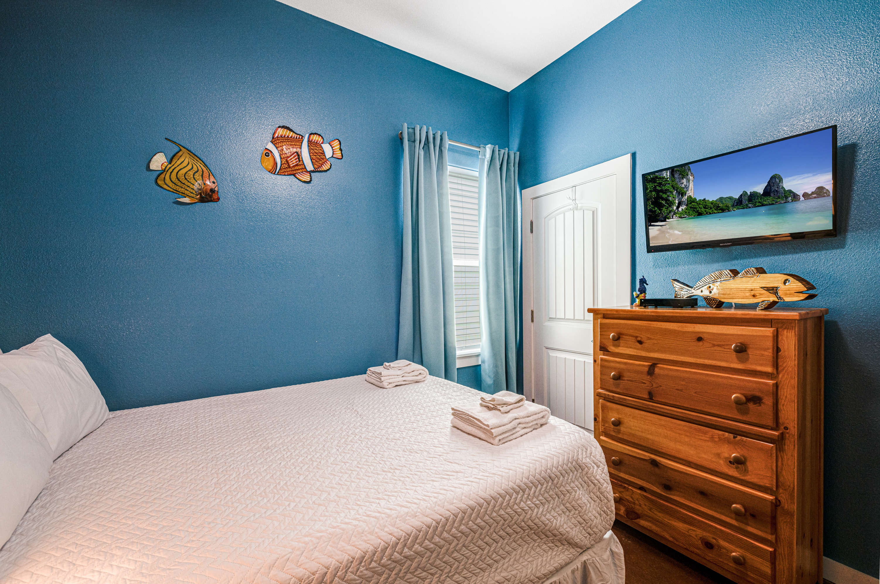 3rd Queen Bedroom Also Offers Mounted TV for Entertainment and Dresser for Storage