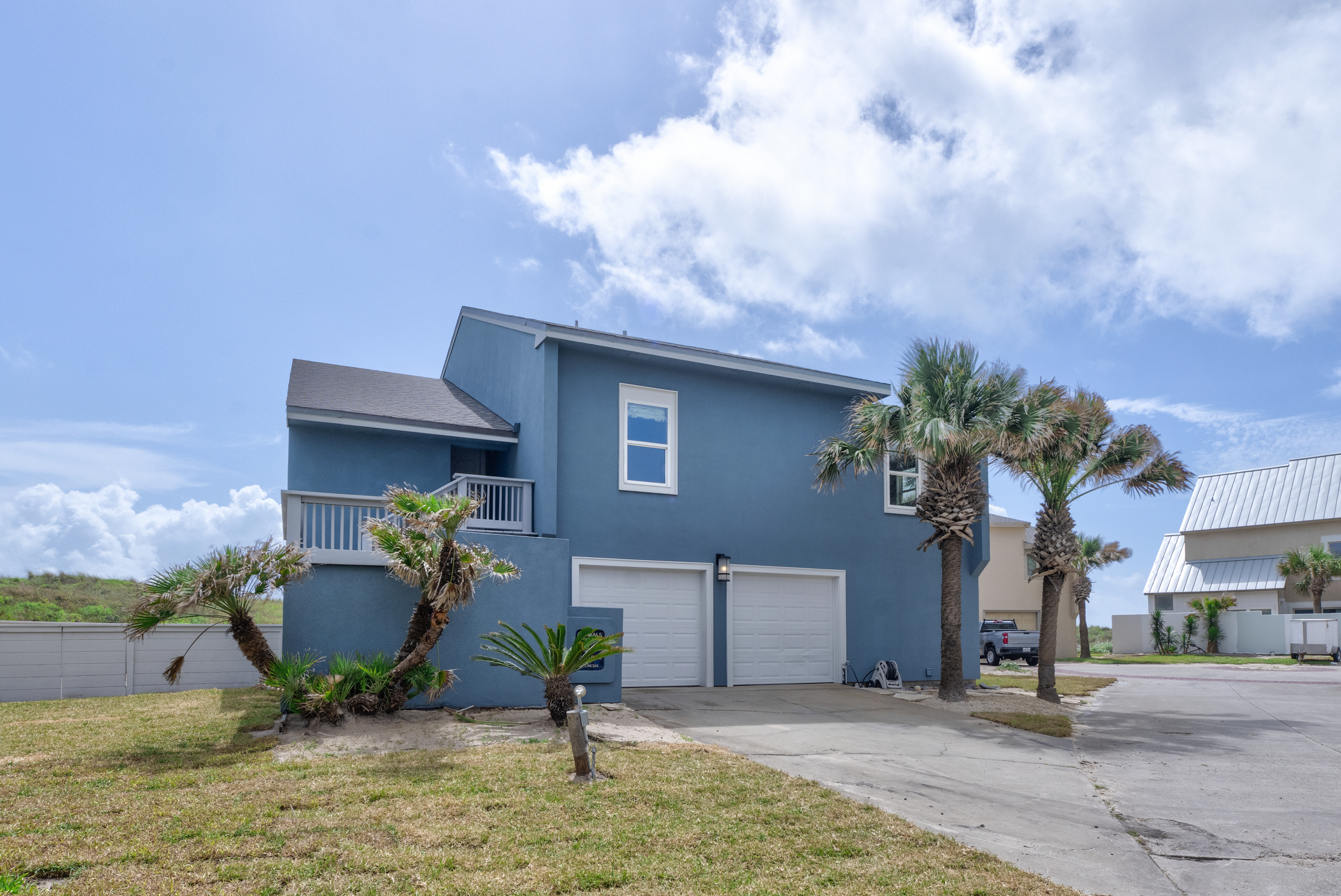 Tropical Lanscaping and Beachy Curb Appeal Welcome You 