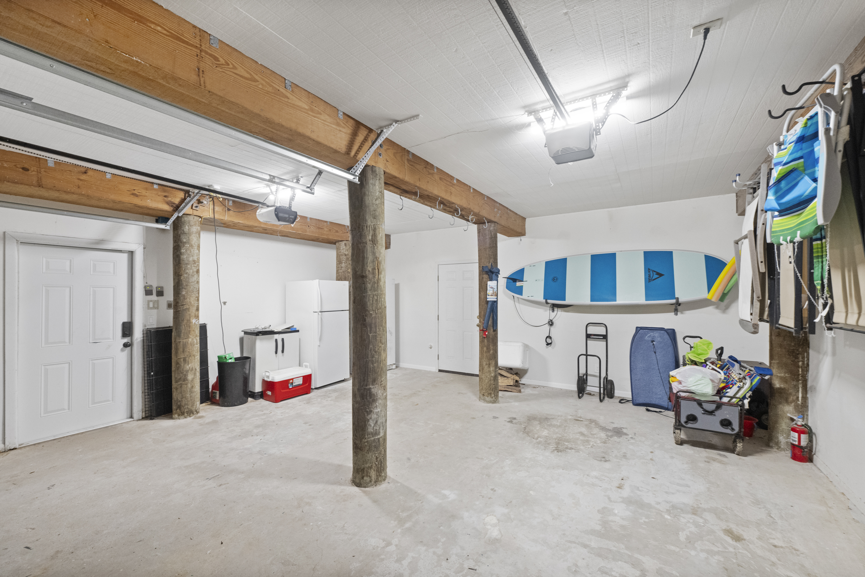 Garage Zone: Featuring Extra Fridge and Freezer, Tesla Charger, and Beach Bonus Accessories 