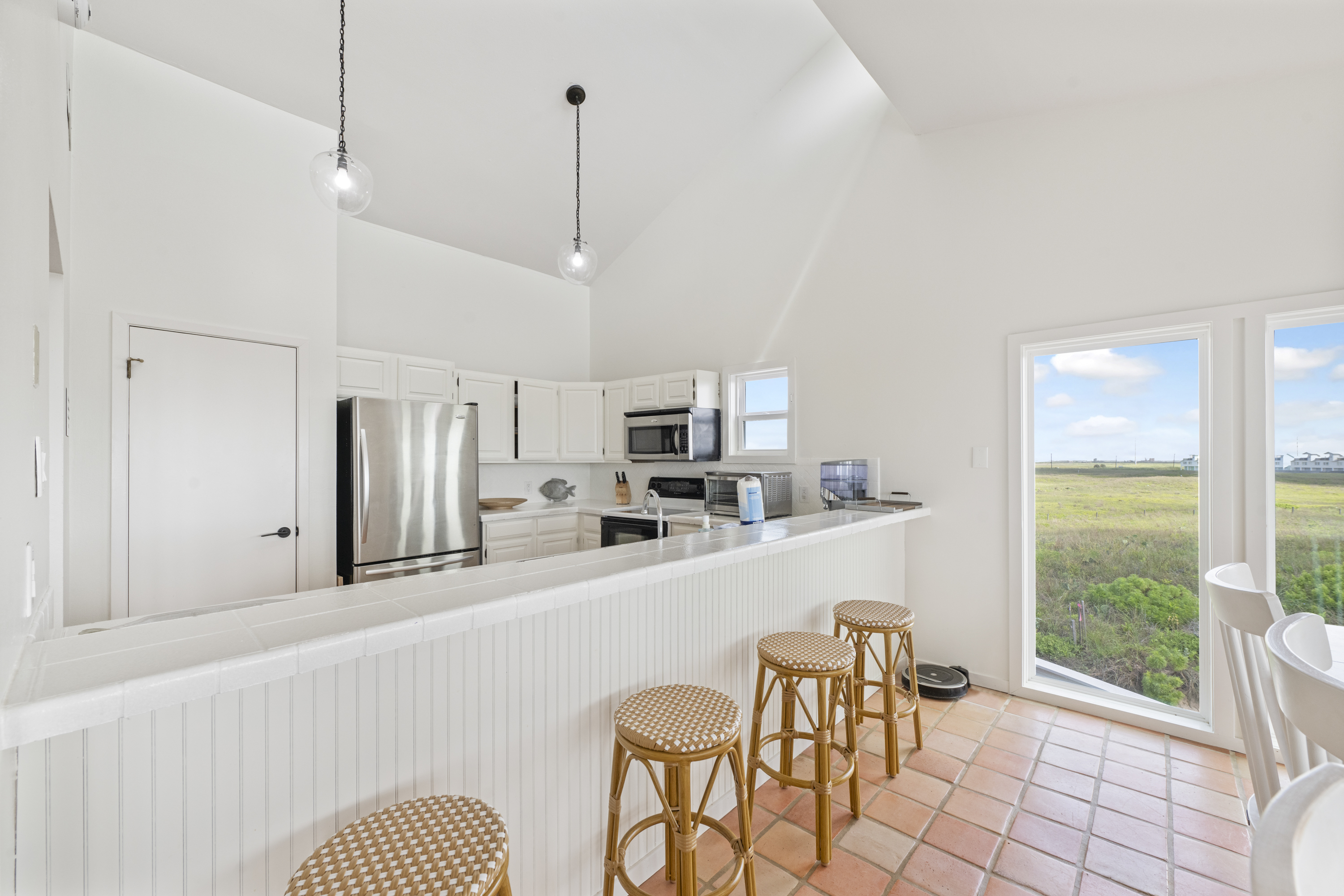 Open Kitchen Flows into Dining Area with an Additional 4 Stools at Kitchen Counter 