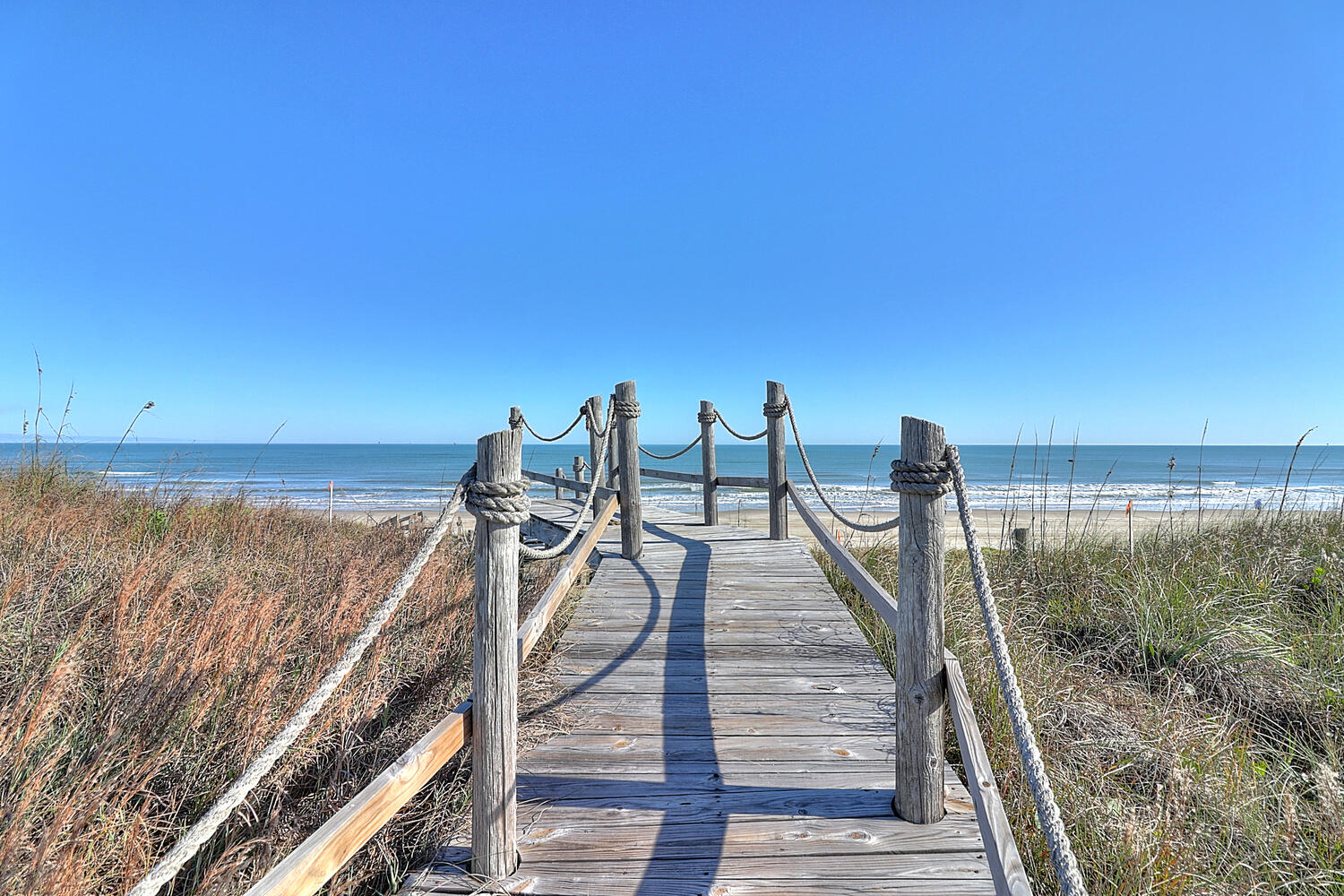 Follow the Boardwalk to Sun-Drenched Shores and Rolling Waves
