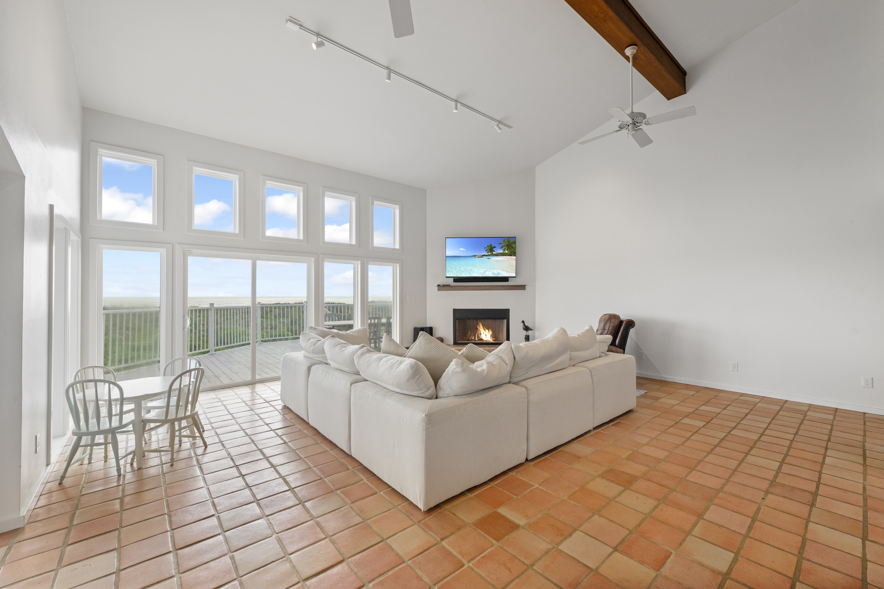 Oceanfront Living: Deck Access & Panoramic Beach Views from Living Room