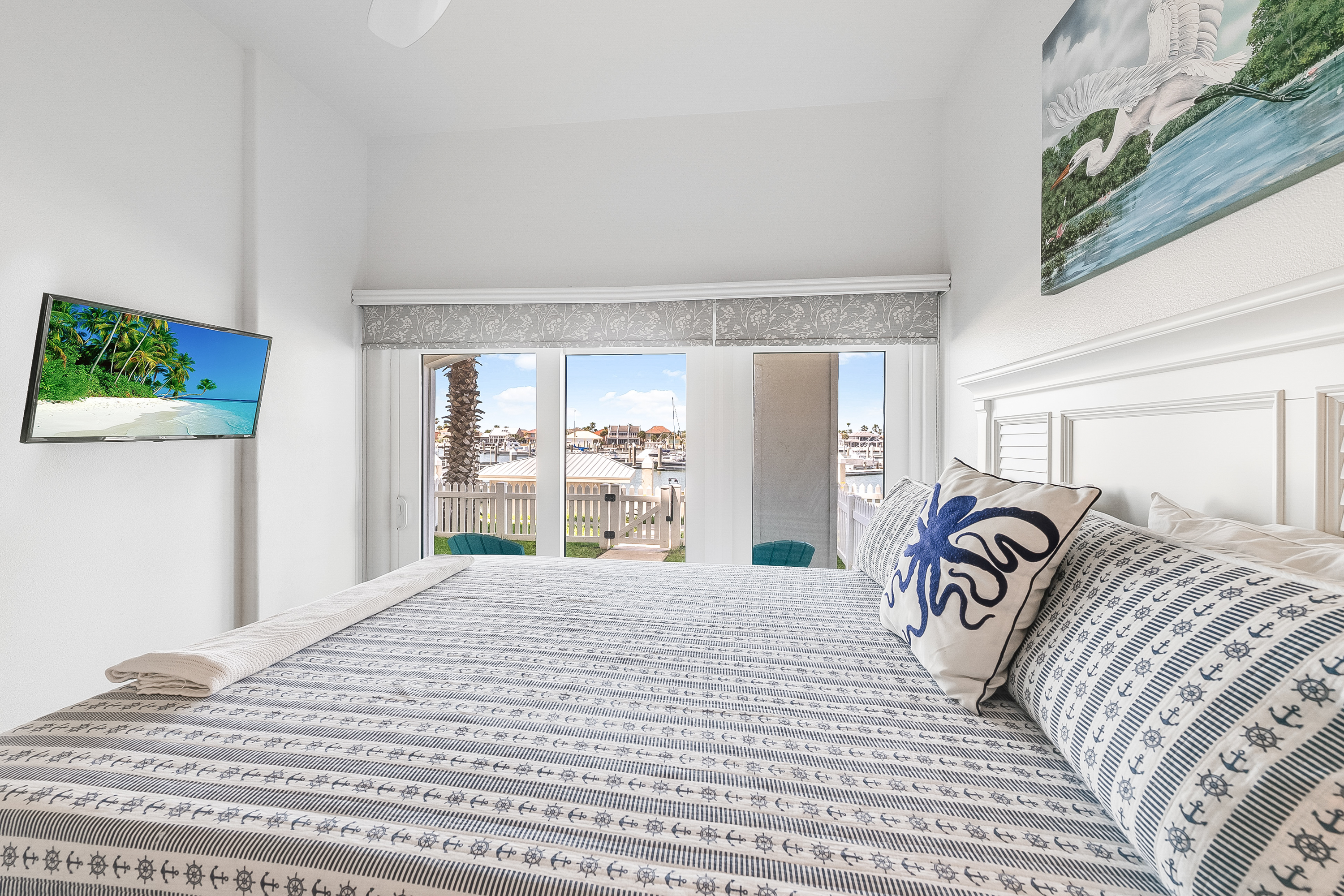 Patio Access to Marina Views and A Mounted TV to Unwind in This 1st Floor Queen Suite 