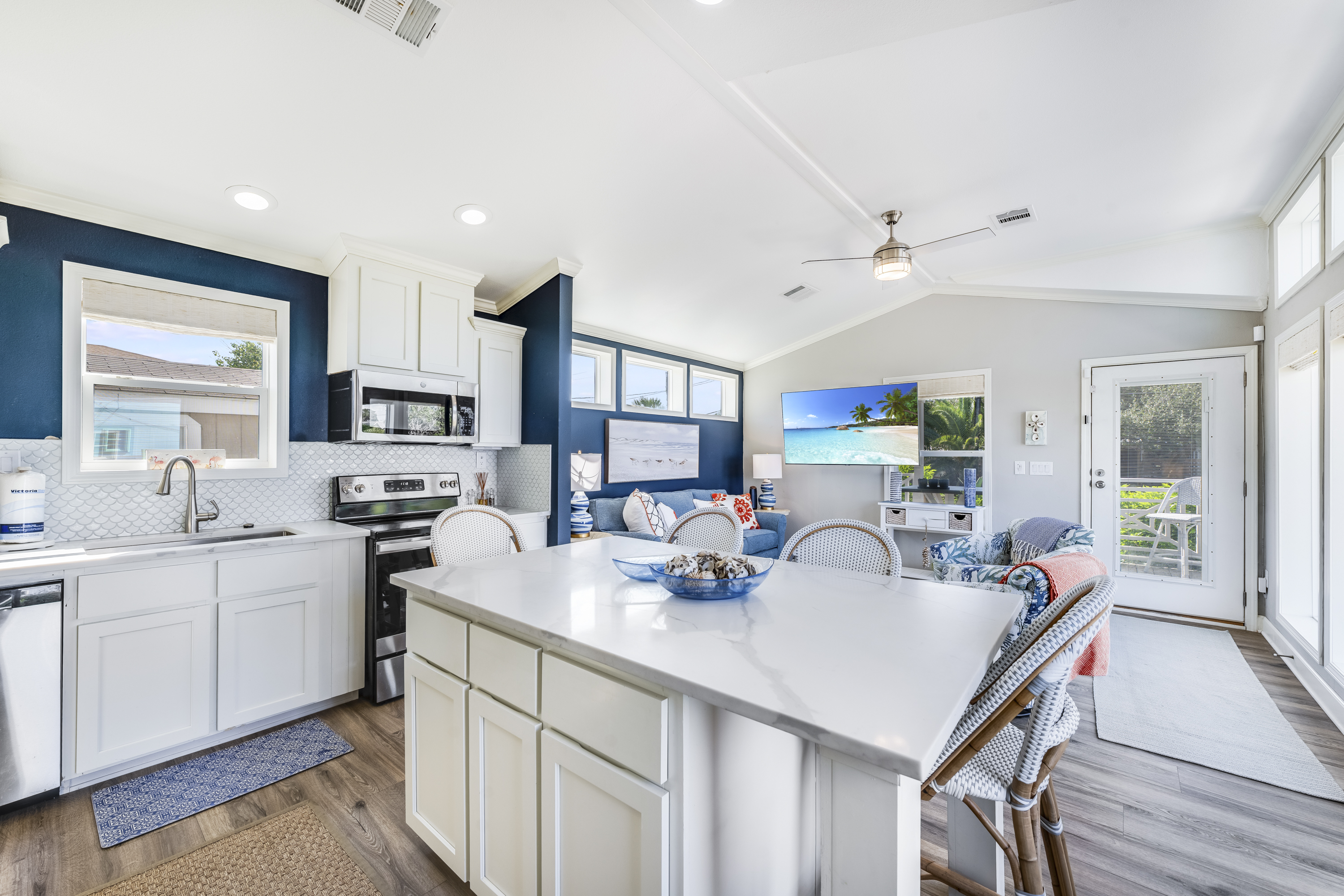 The bright, beautifully designed kitchen features a convenient breakfast bar — an inviting spot to gather for morning coffee or a quick family meal before the day begins.