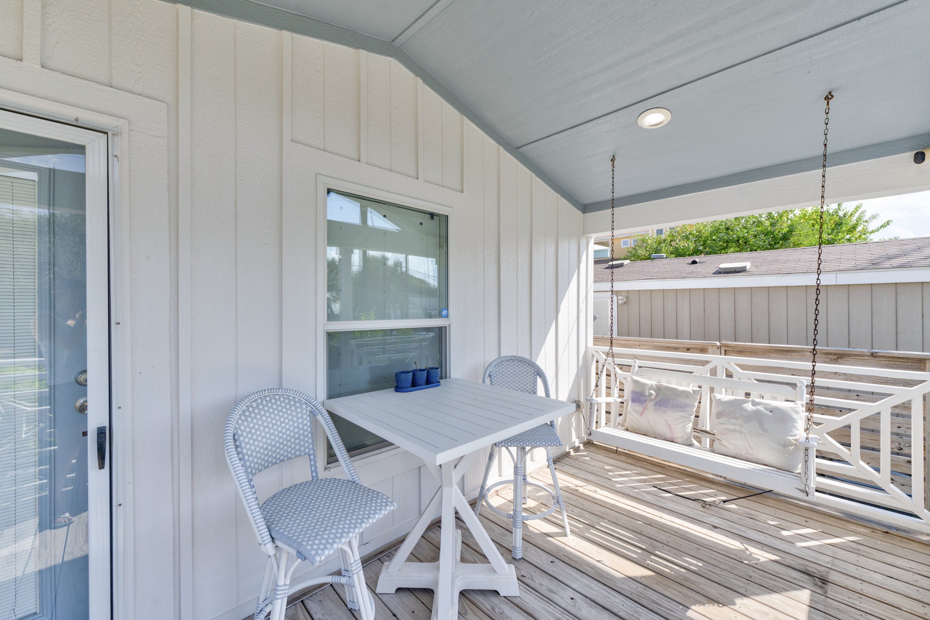 The covered porch offers a welcoming space to gather — complete with a table for morning coffee and a cozy swing for quiet moments and easy conversation.