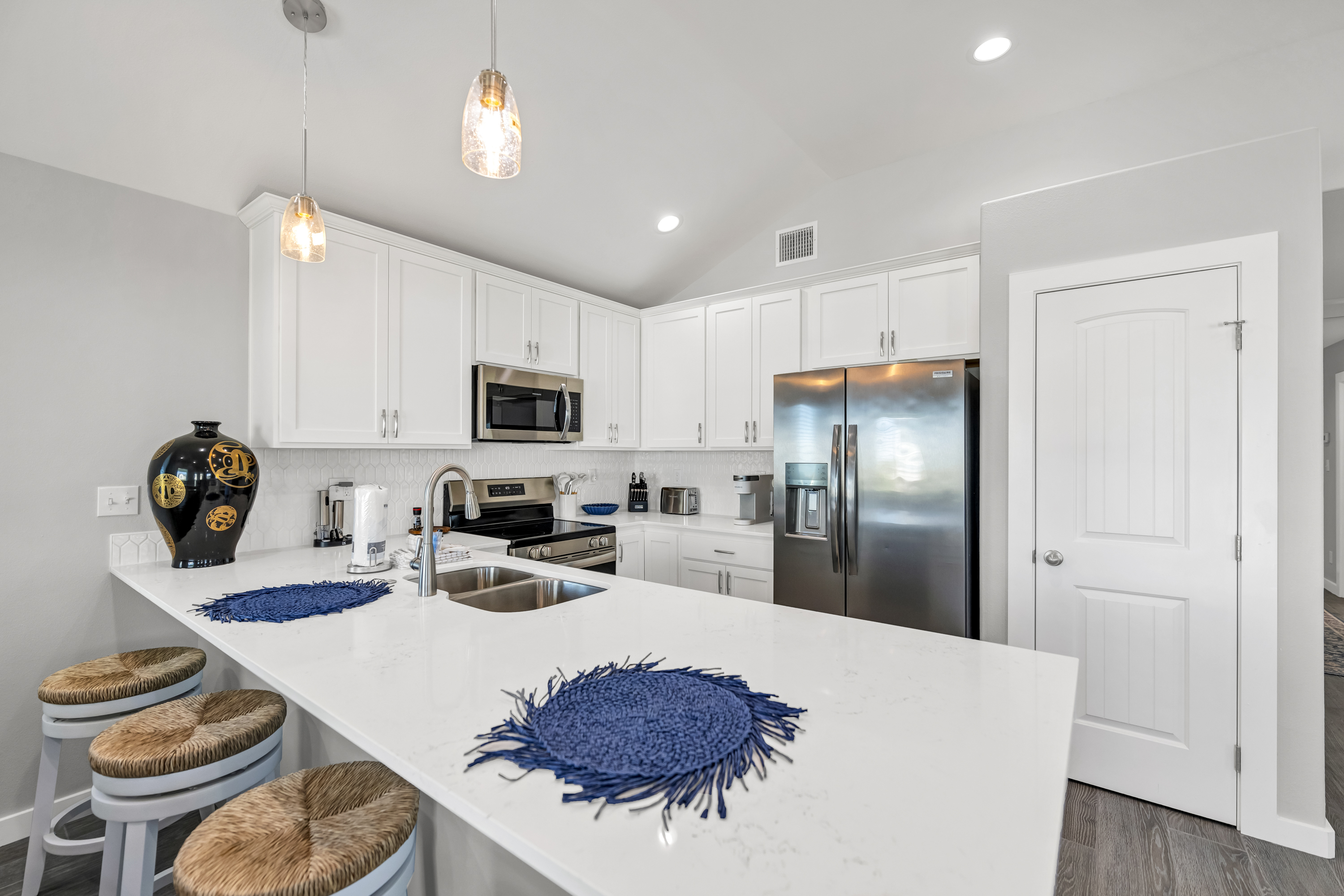 A bright, open kitchen with a spacious island — perfect for family gatherings or quick beach-day bites.