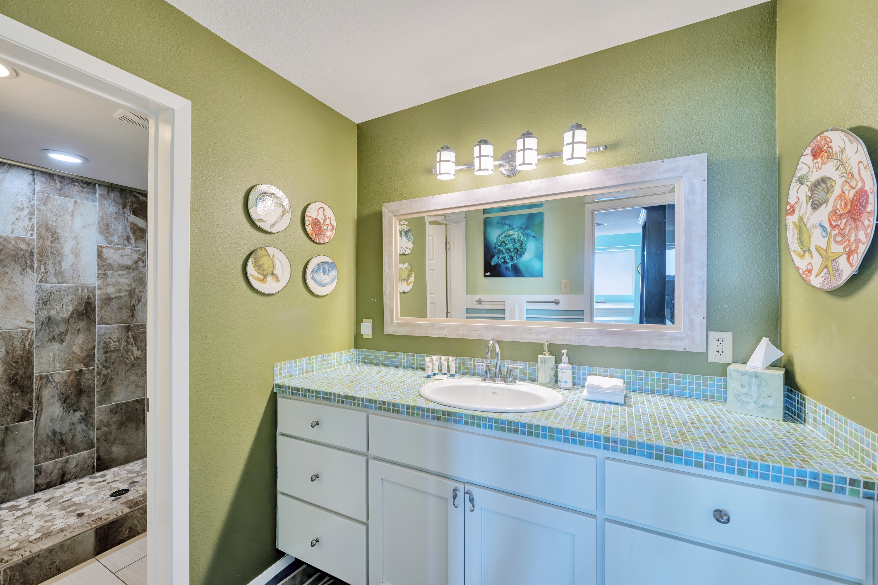 2nd Floor shared bathroom with a spacious vanity and coastal decor pieces 