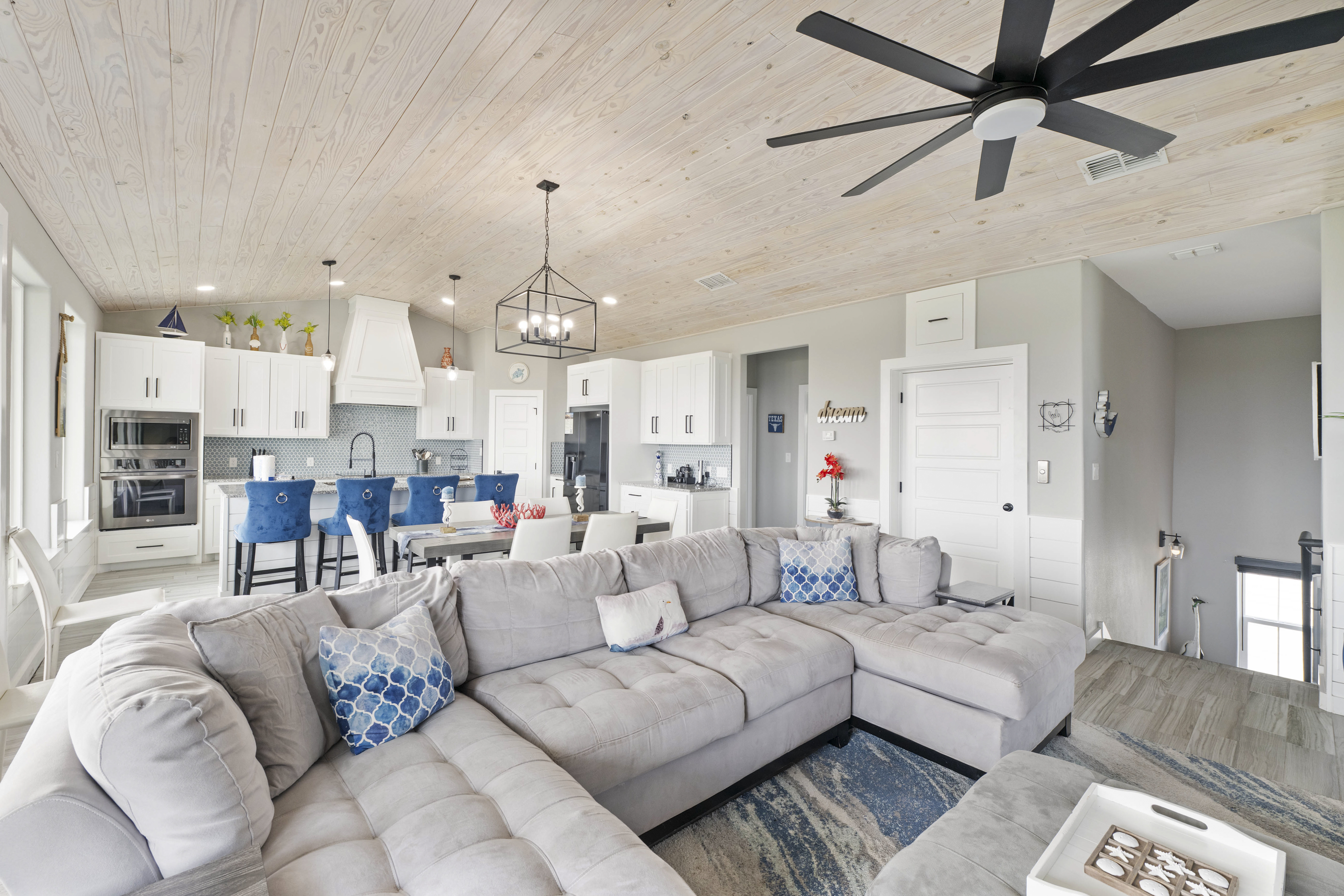 Coastal charm meets comfort in this inviting, spacious living area designed for effortless relaxation.