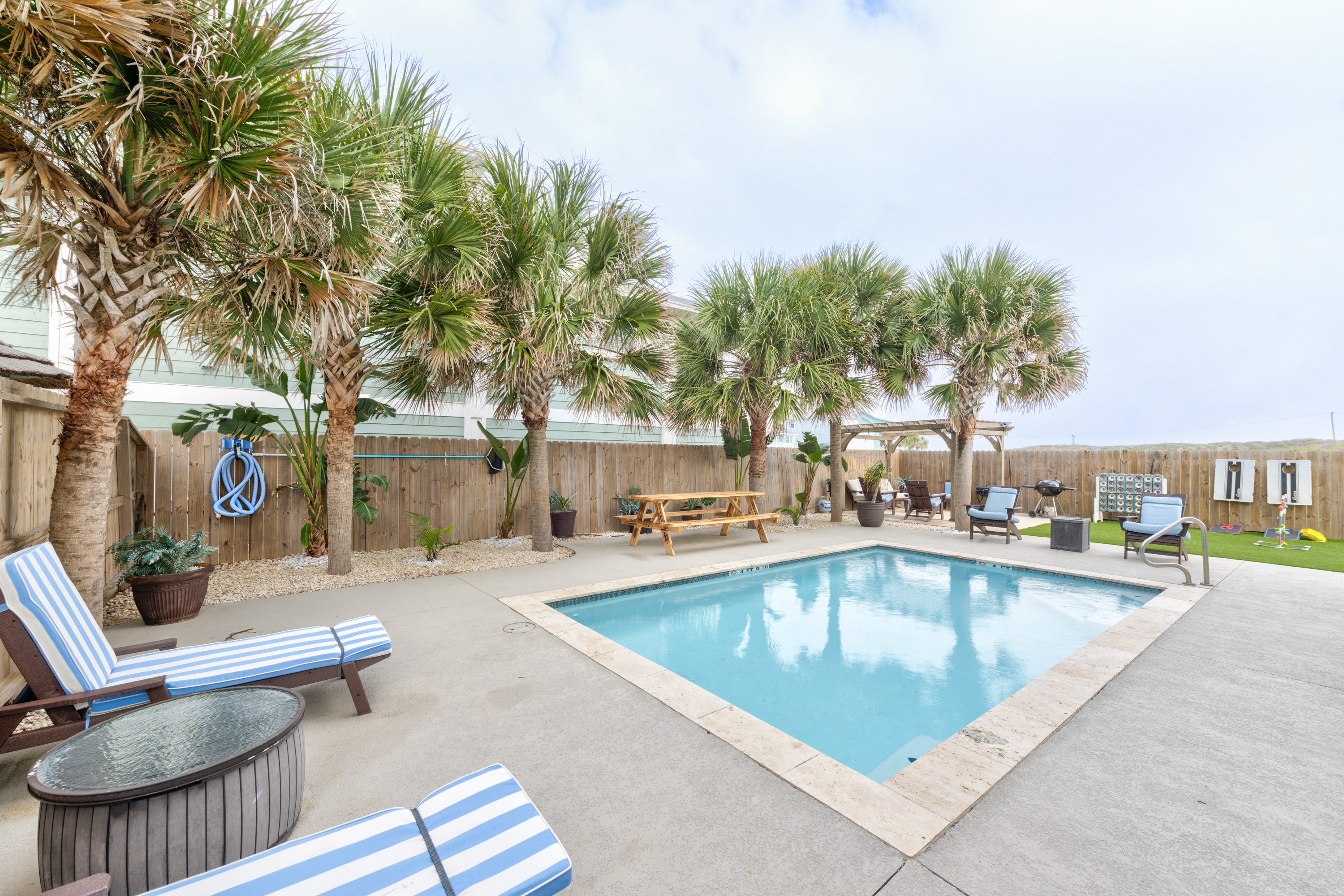 Lounge, swim, grill, and play—this picture-perfect backyard has it all!