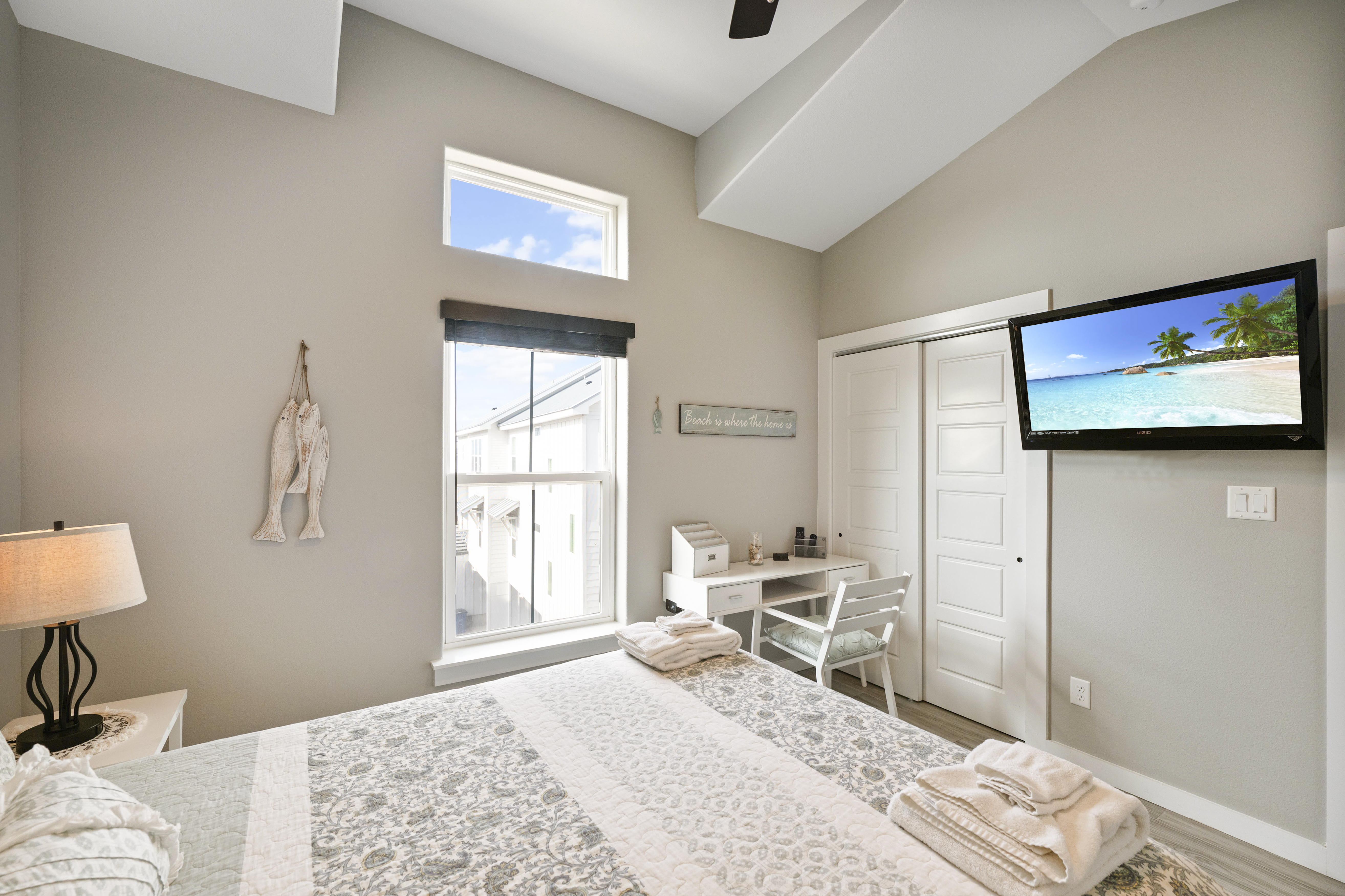 A spacious Queen-size retreat with and a mounted TV for laid-back coastal comfort