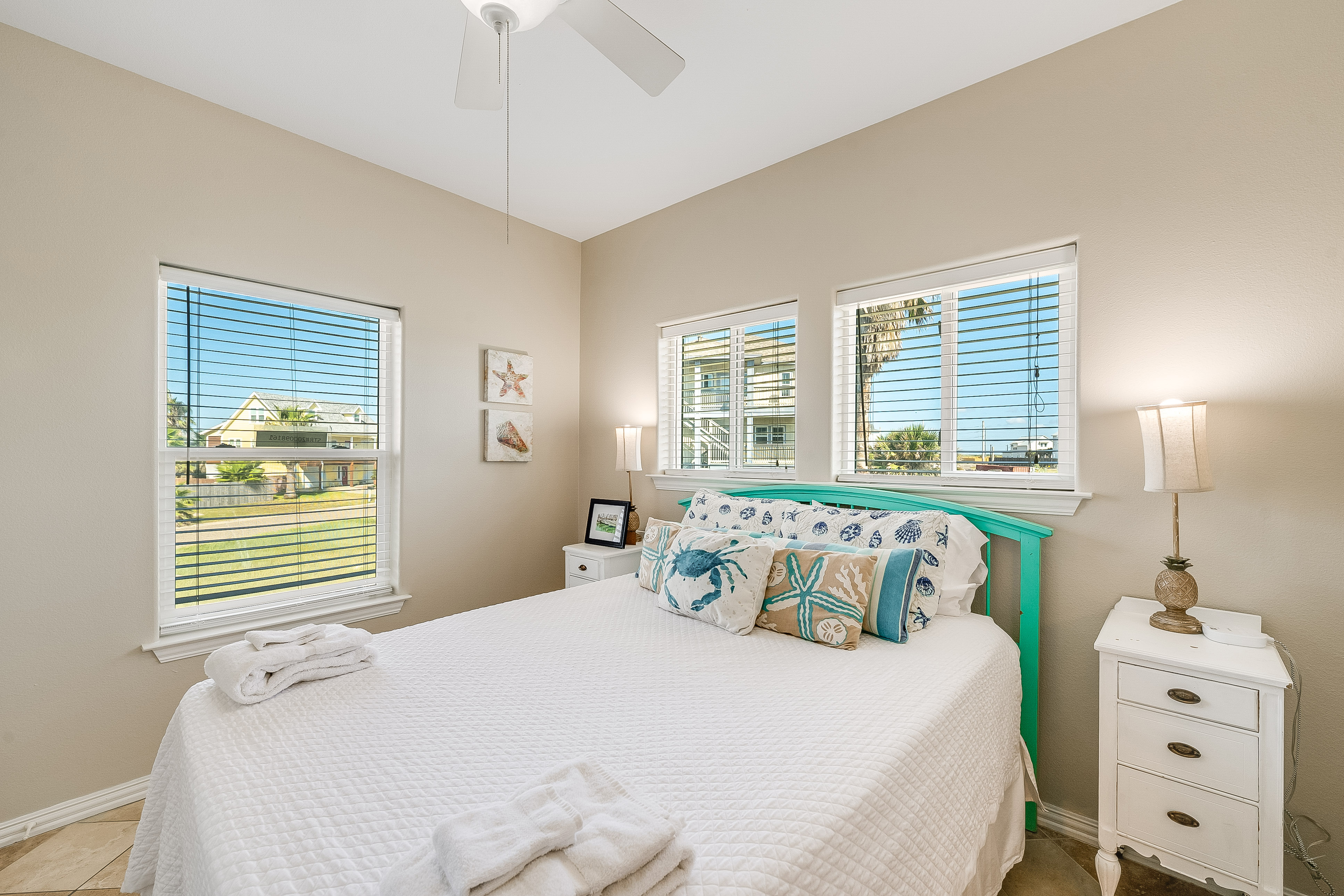 Relax and unwind in the second floor Queen bedroom featuring a TV and shared bath access.