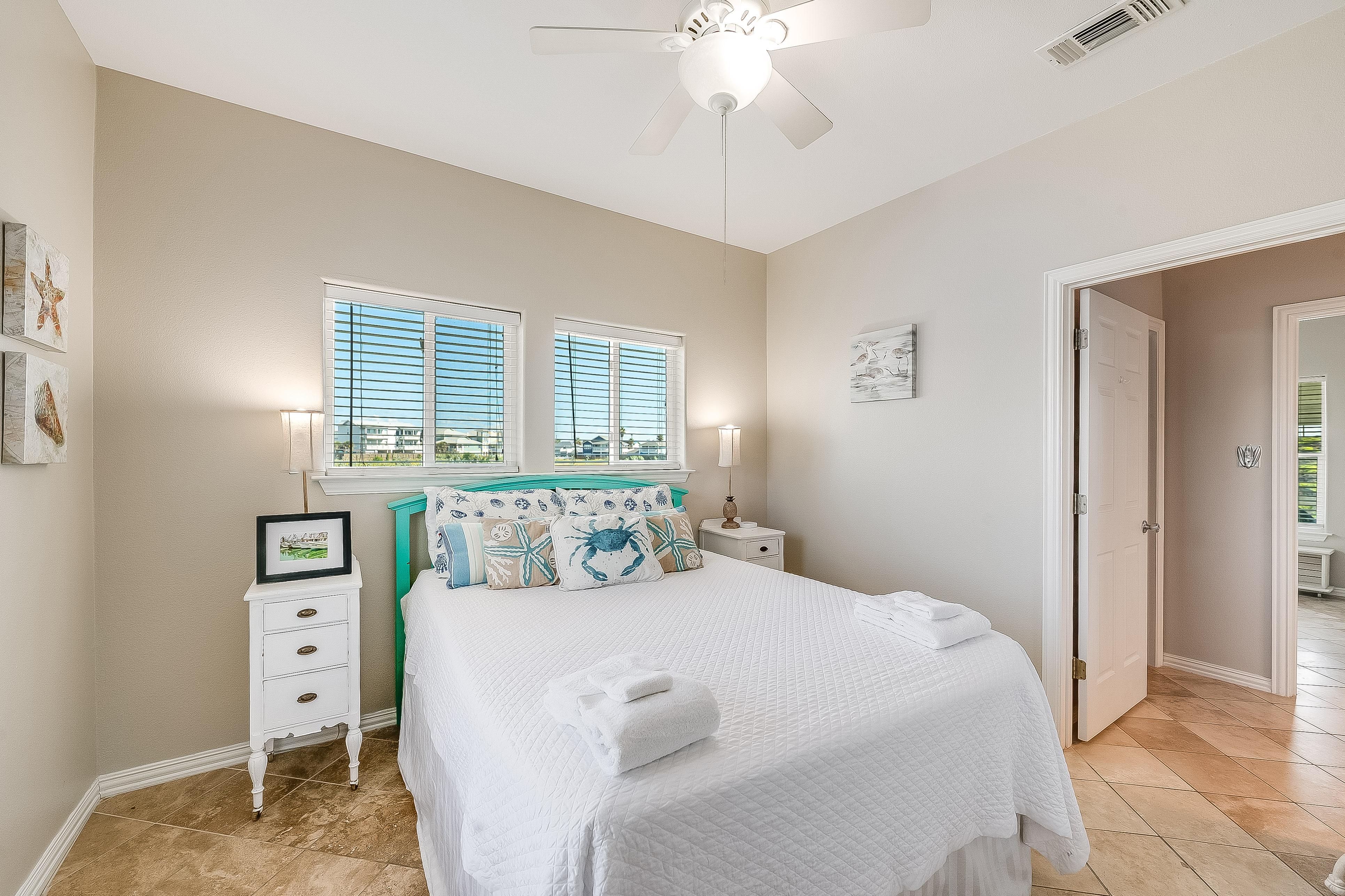 Enjoy cozy nights in the second floor Queen bedroom with TV and a shared bath.