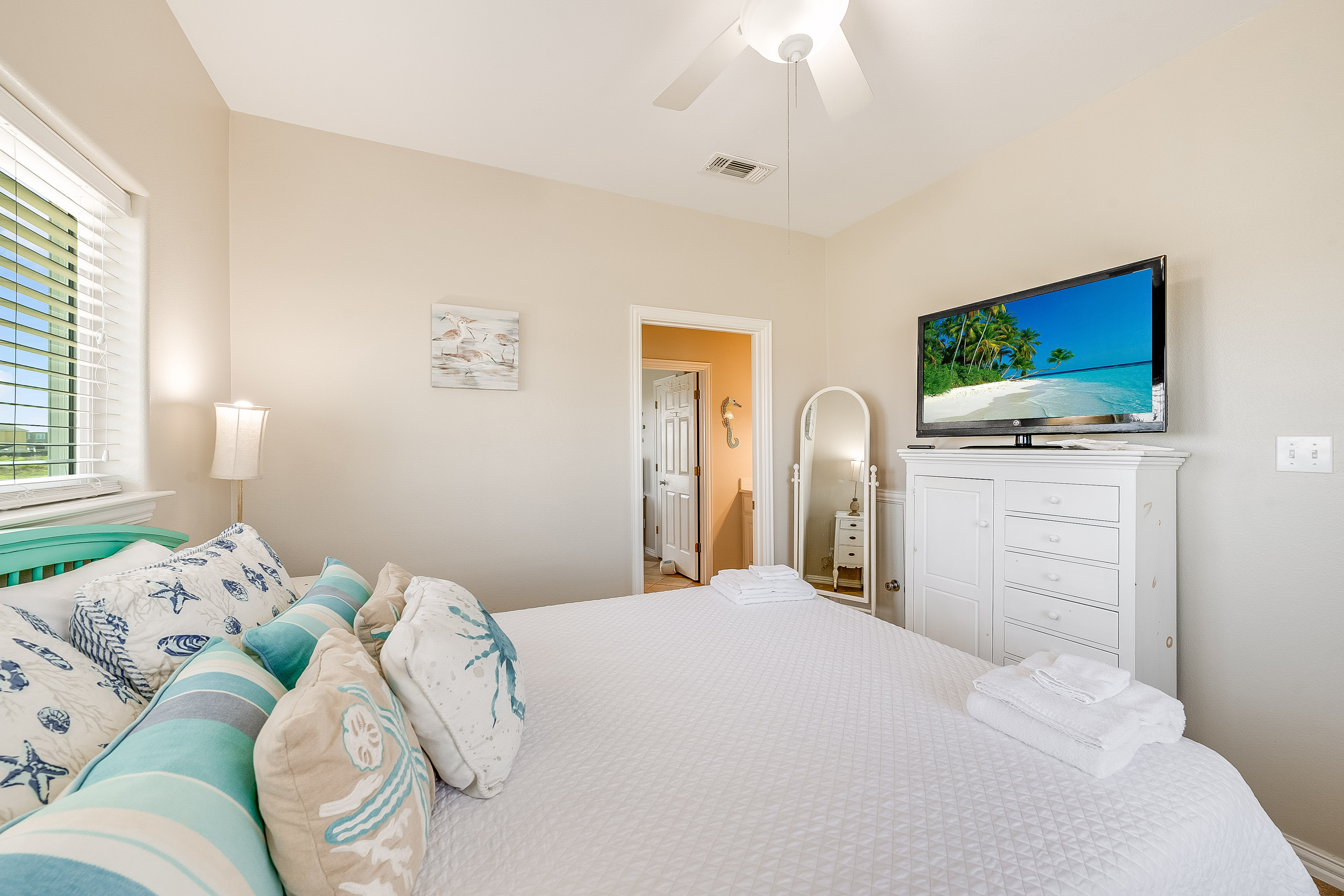 Find your sweet beach dreams in the comfy second-floor Queen bedroom with shared bath access.