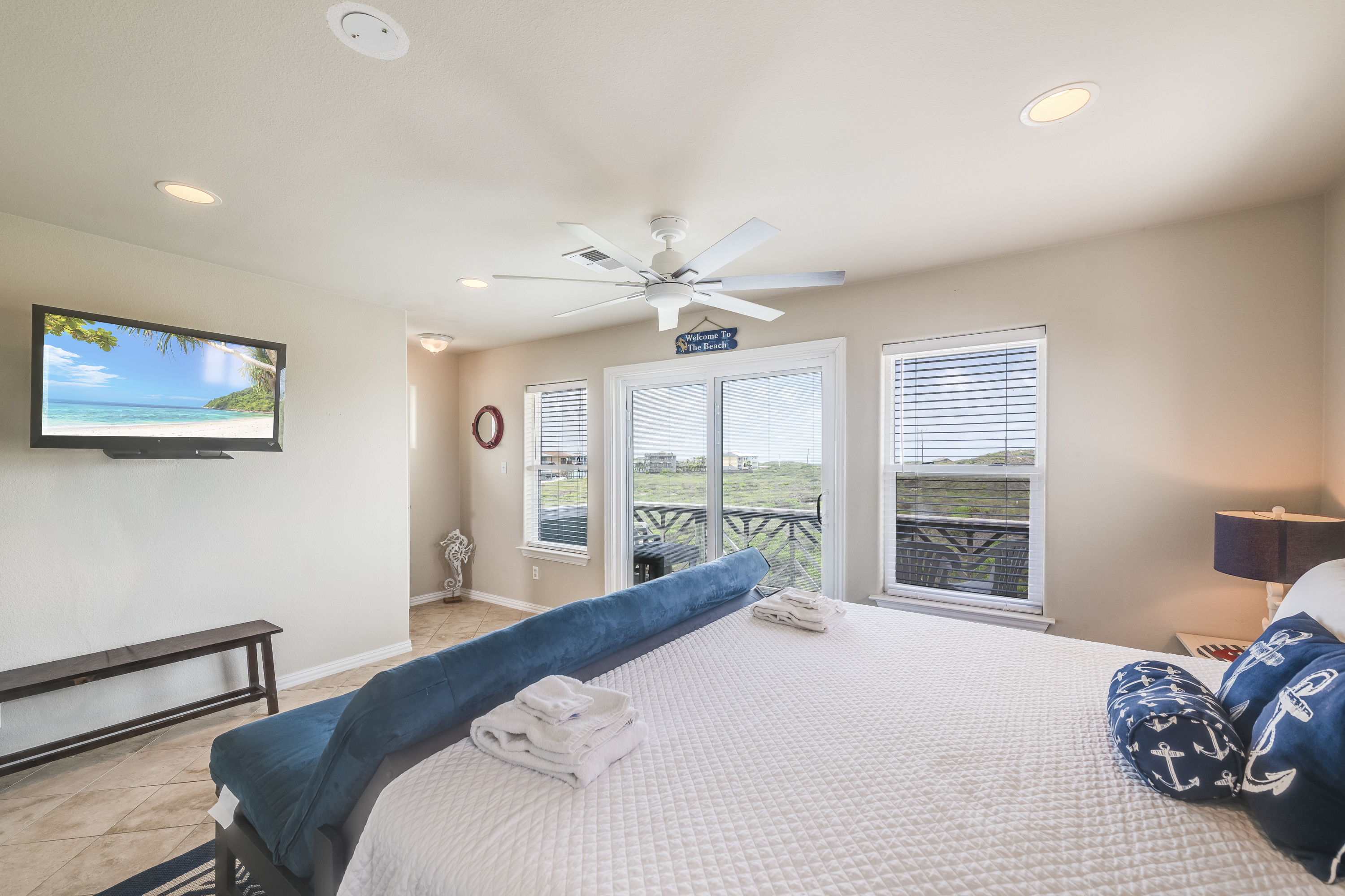 Private king-size sanctuary offers ensuite bath, futon, patio access and mounted TV.