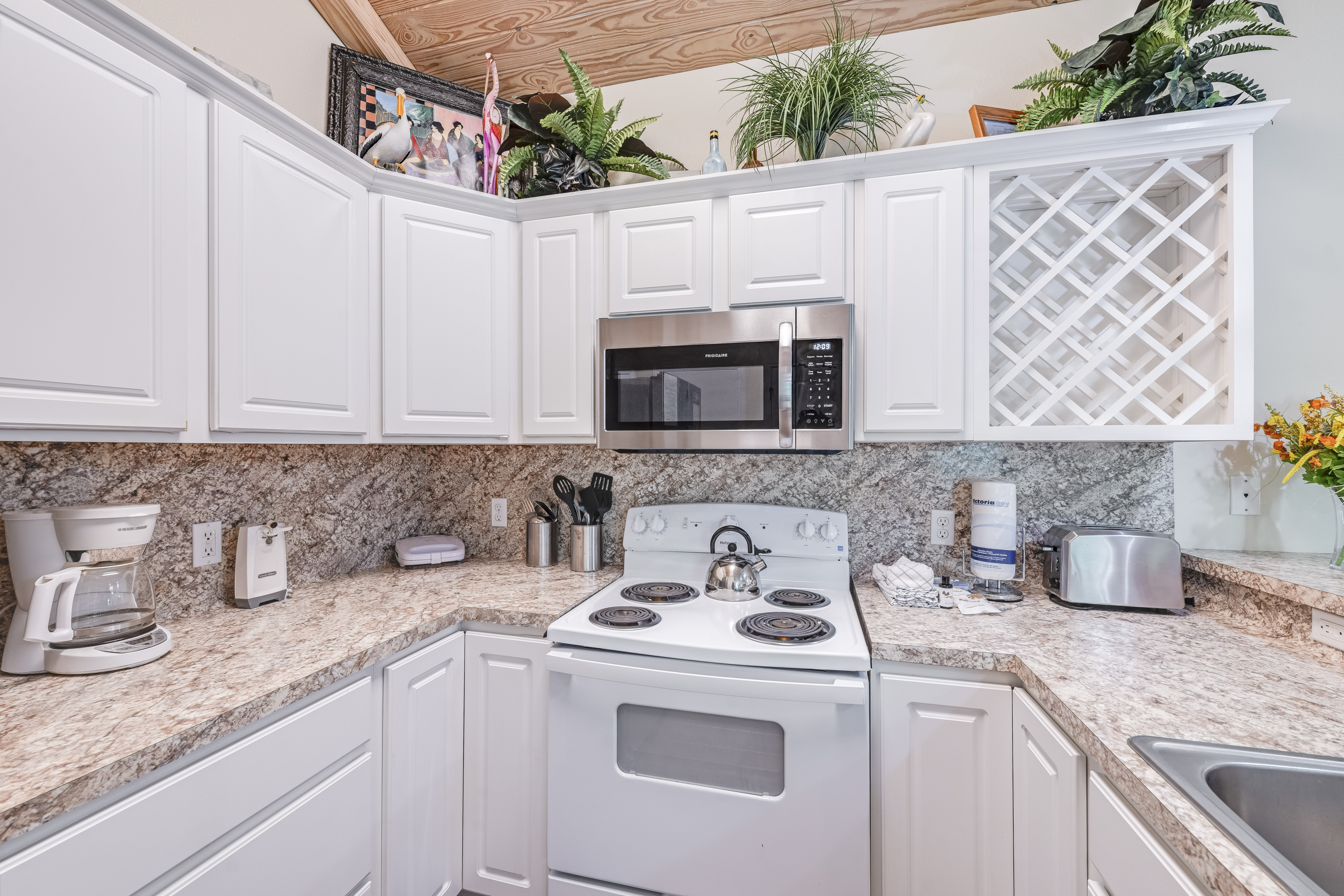 Experience culinary charm in this cozy kitchen featuring a drip coffee maker