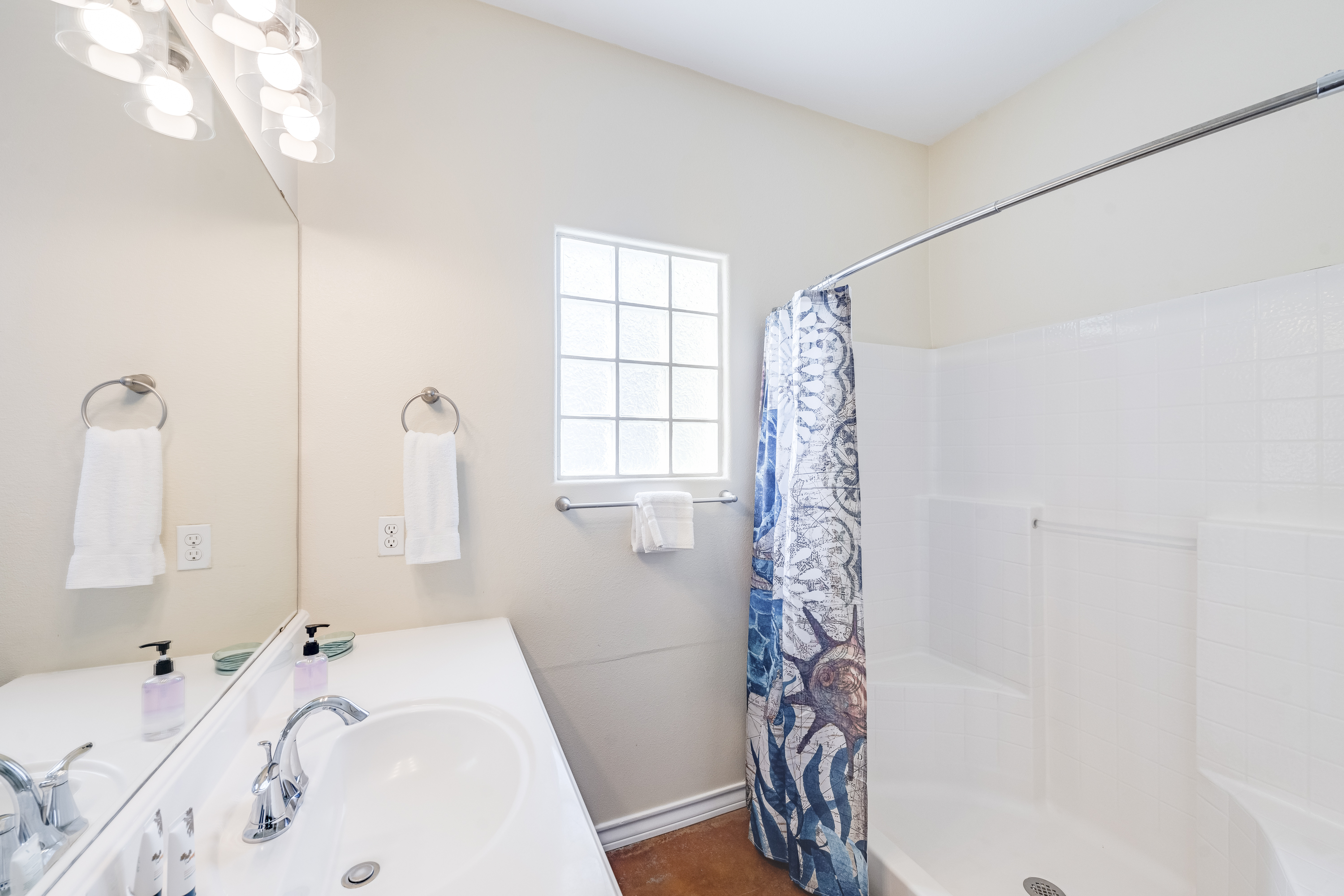 Sleek, spa-inspired full bathroom with a walk-in shower and modern fixtures — your own private retreat after a day in the sun