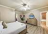 Spacious first-floor master suite with a comfortable king bed and TV to relax and unwind. 