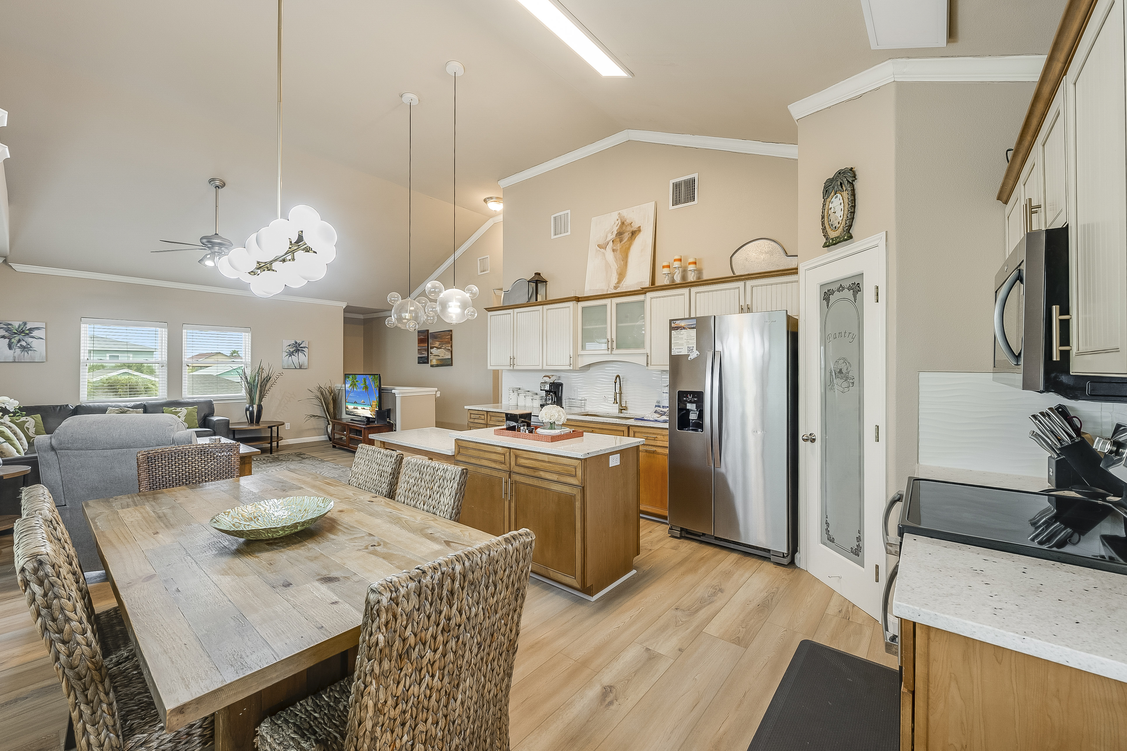 The kitchen, dining, and living areas blend seamlessly for a bright and airy feel