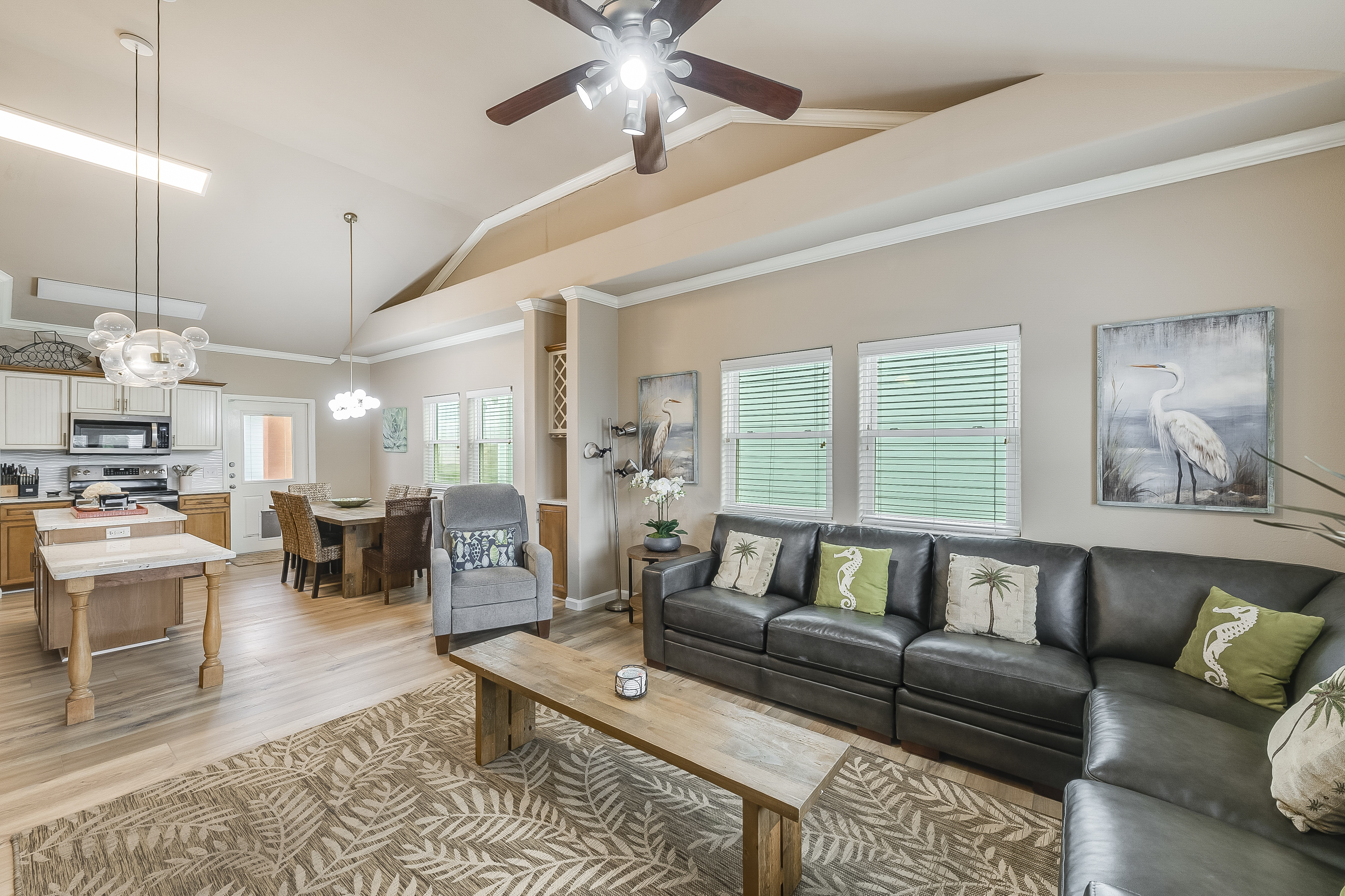 Relax and unwind in this inviting living area, featuring direct access to the dining space and outdoor deck
