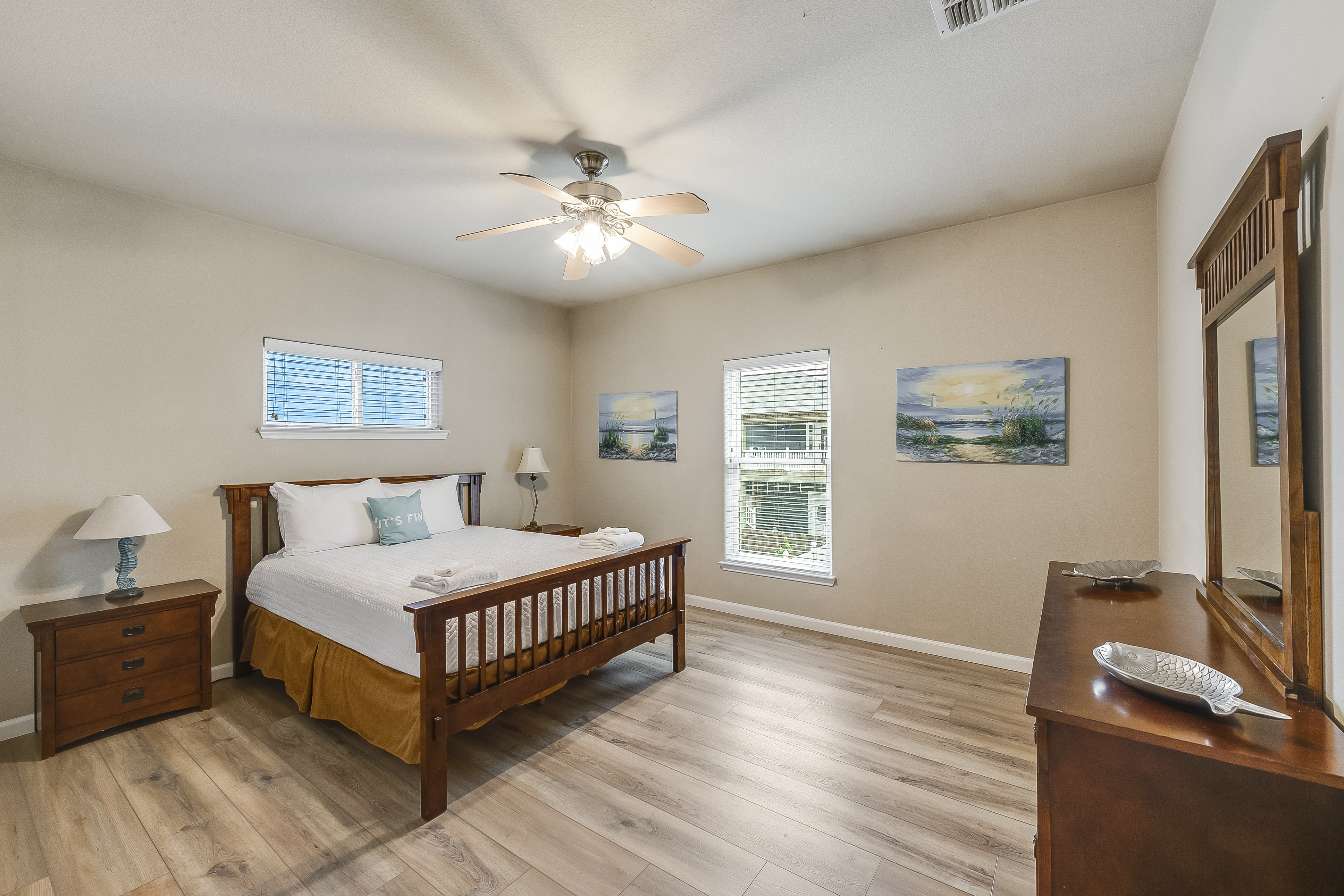 Spacious primary bedroom equipped with a comfortable queen-size bed 