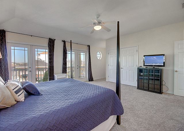 Main bedroom with king TV and balcony access