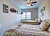 Two full beds in bedroom with ceiling fan