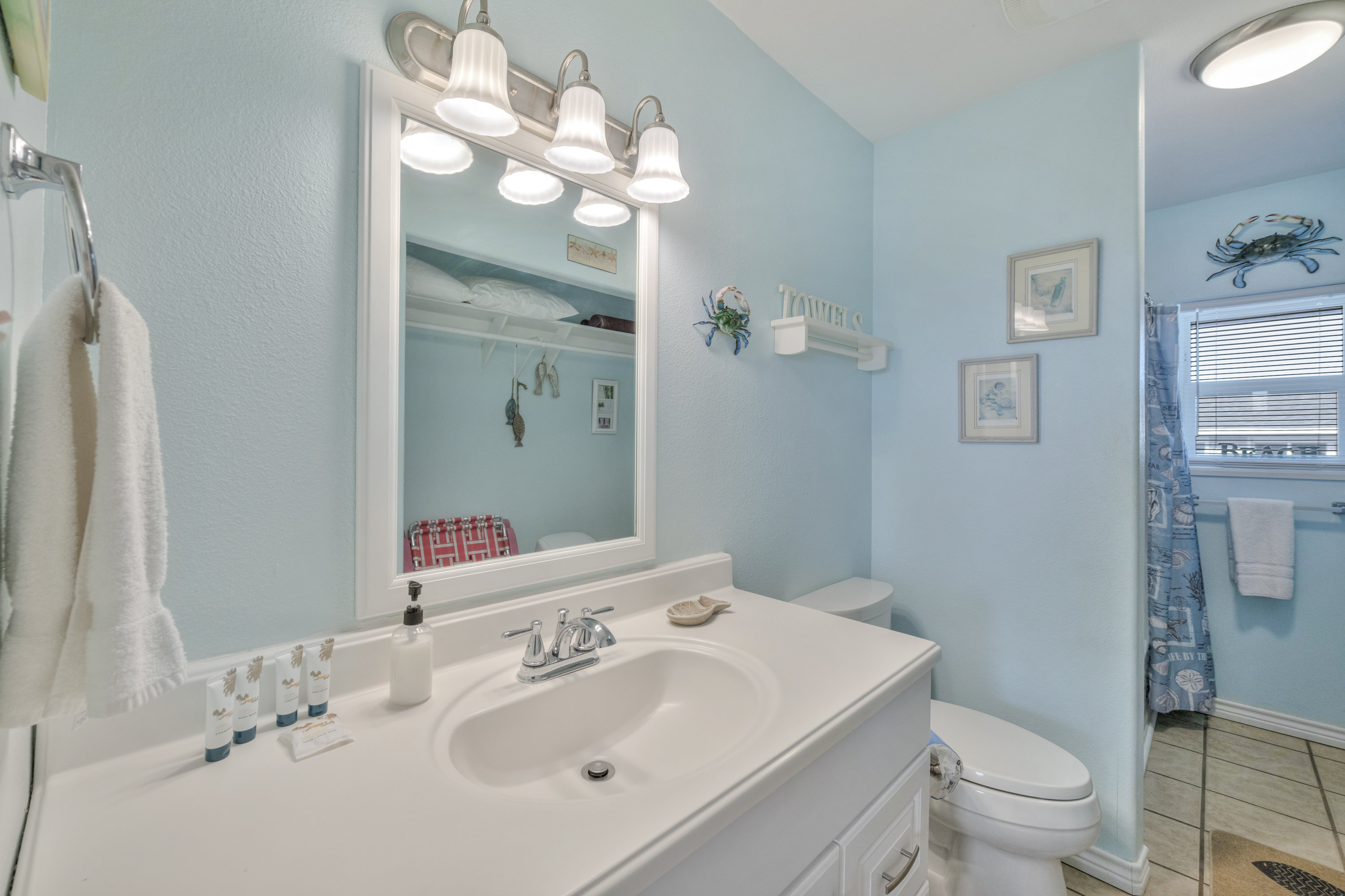 This stylish full bath features a spacious vanity, and a calm, coastal color palette for a relaxing refresh