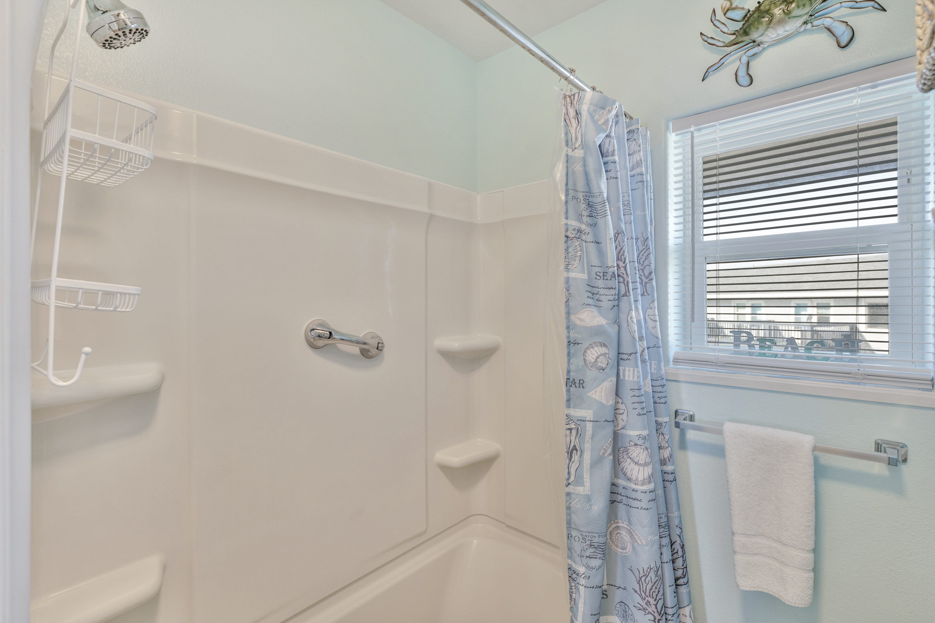 Refresh and reset in this full bathroom, complete with a shower/tub combo and crisp lighting — perfect after beach adventures.