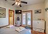 Queen bedroom suite, with small murphy bed with mounted TV and patio access