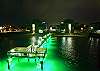 Fishing pier with night time green lights