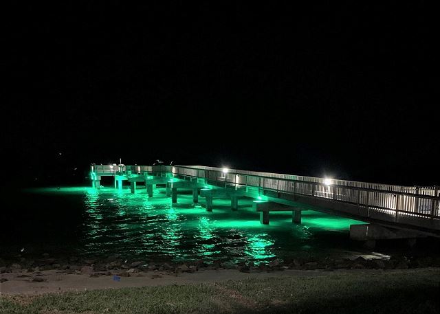 Pier is lit at nighttime