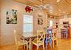 Tropical ambiance in this dining area with seating at table and breakfast bar