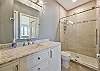 The remodeled en-suite master bathroom features a large walk-in shower