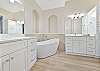 New remodeled primary bathroom with luxurious freestanding tub and spacious walk-in shower
