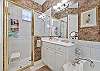 The en-suite primary bathroom features double sinks, a large walk-in shower and separate garden tub