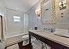 The guest bathroom features a shower tub combination