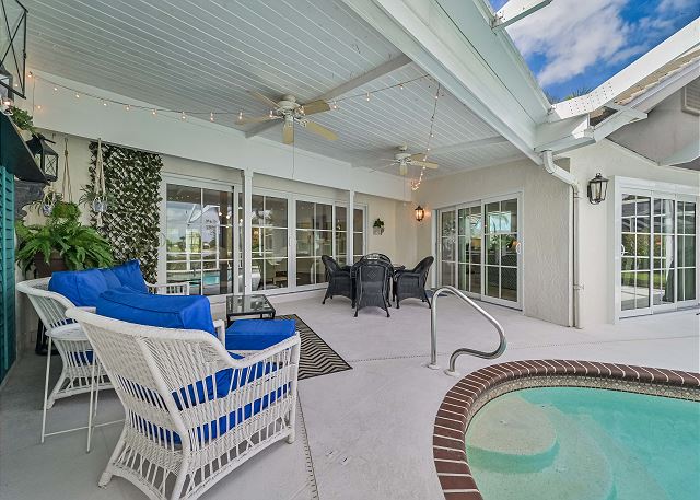 The screened in pool area is equipped with a cabana bathroom, lounge chairs, seating and dining area with BBQ, and offers beautiful lake view!