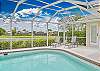 The screened in pool area is equipped with a cabana bathroom, lounge chairs, seating and dining area with BBQ, and offers beautiful lake view!
