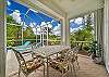 Covered outdoor dining area, and lounge chairs at the pool deck