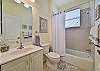 The guest bathroom features a shower-tub combination