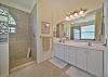 The master bathroom features dual sinks, a large walk-in shower and separate tub.