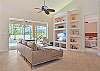 The living features an inviting leather sectional couch and flat screen TV.
