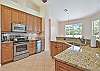 Fully equipped kitchen with stainless steel appliances and granite counter-tops
