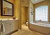 This home features a spacious master bathroom with his and her vanity and separate tub and walk-in shower