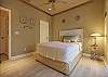 Beach style decorated guest bedroom with sliding doors to the screened in pool area.